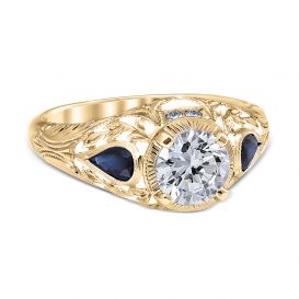 Wreathed Pear filigree engagement ring with pear shape blue sapphire side stones in yellow gold.